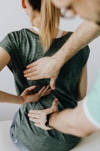 Chiropractor performs manual adjustment on a patient's back to alleviate discomfort and improve posture.