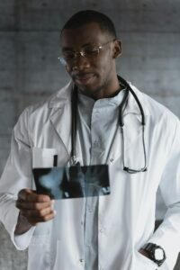 Medical professional carefully examines an X-ray image in a clinical setting.